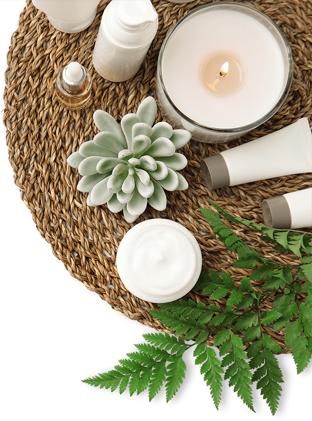 Beauty products positioned around a candle